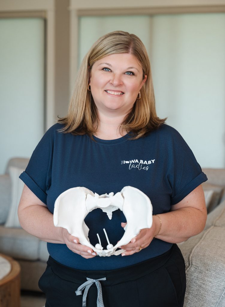 Iowa doula trainer, katie nyberg, teaching with a pelvis model during birth doula training