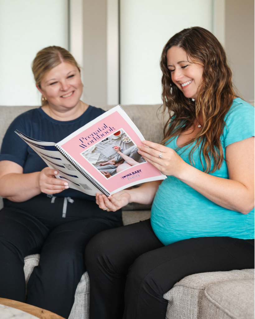 Iowa birth doula reviewing a prenatal workbook with a pregnant client
